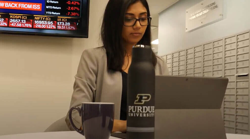 Purdue University alumn working on a tablet in an office