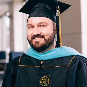 Ryan Melvin in Purdue University graduation cap and gown
